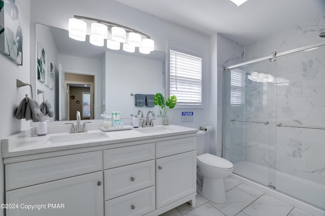 full bath featuring marble finish floor, a sink, a marble finish shower, and toilet