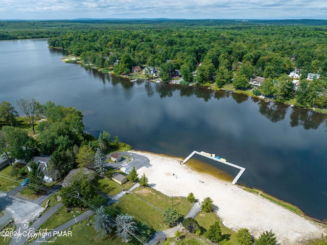 aerial view with a water view and a wooded view