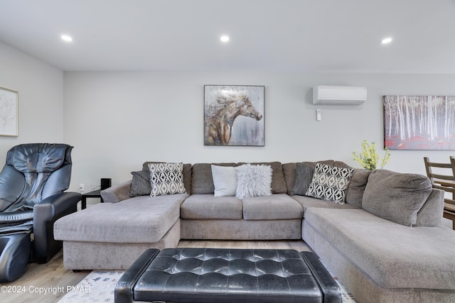 living area featuring a wall mounted air conditioner, wood finished floors, and recessed lighting