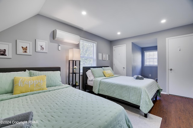 bedroom featuring lofted ceiling, multiple windows, dark wood-type flooring, and an AC wall unit