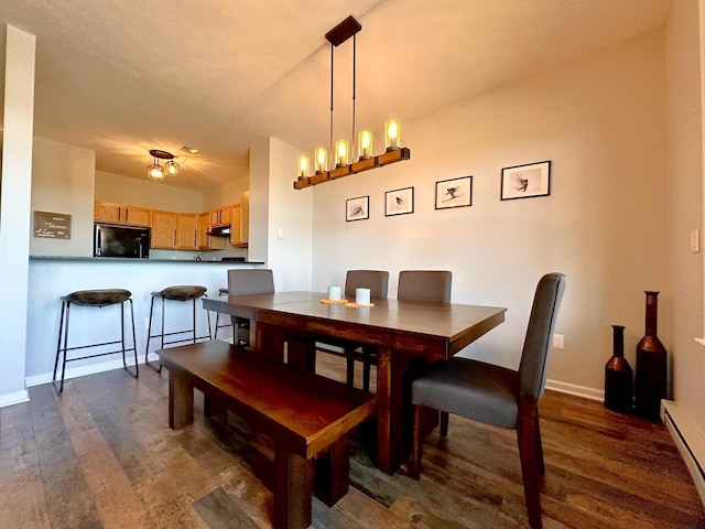 376 Linden Ct Unit 376, Tannersville, PA 18372 - dining room with a baseboard heating unit, dark wood-style floors, baseboards, and a chandelier