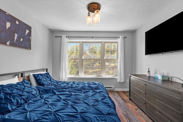 376 Linden Ct Unit 376, Tannersville, PA 18372 - bedroom with dark wood-type flooring, a textured ceiling, and a baseboard heating unit