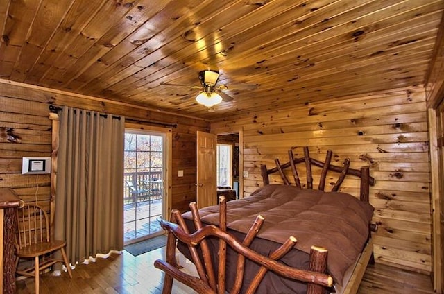 bedroom featuring wood ceiling, hardwood / wood-style flooring, access to outside, and wood walls