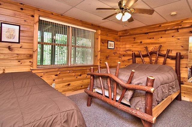 carpeted bedroom with wood walls