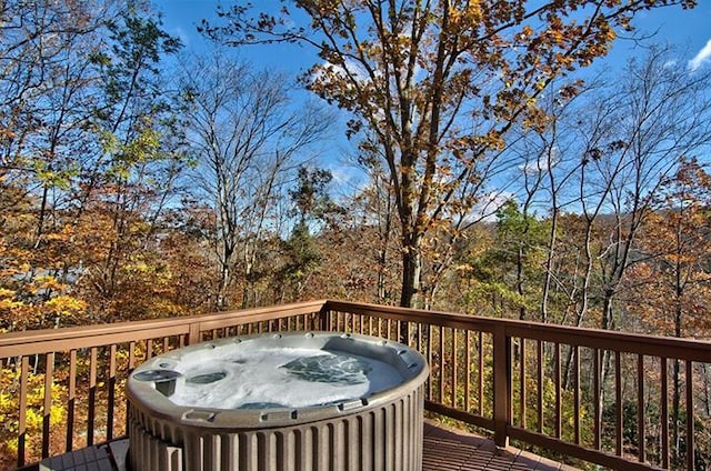 wooden terrace featuring a hot tub