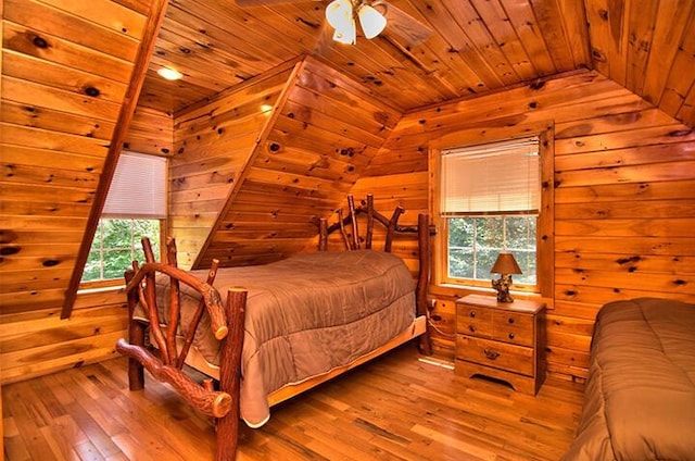 bedroom featuring lofted ceiling, wooden ceiling, hardwood / wood-style flooring, and wooden walls