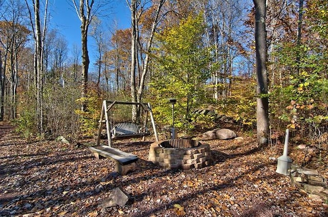 view of yard with an outdoor fire pit