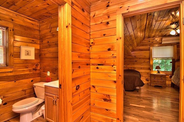 bathroom with wood ceiling, vaulted ceiling, toilet, and wood finished floors