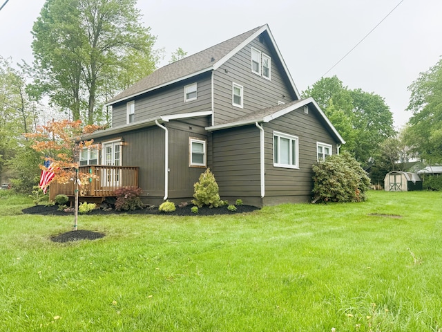 413 Old Rte 940, Pocono Pines, PA 18350 - rear view of house with a storage unit, a wooden deck, an outdoor structure, a lawn, and a shingled roof