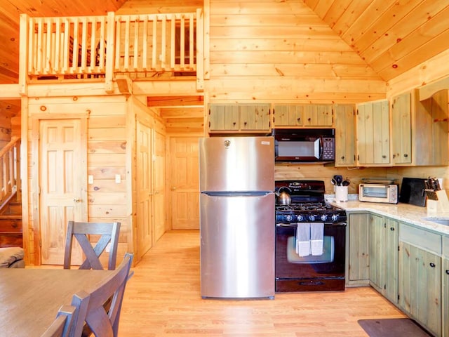 kitchen with black appliances, wood walls, light wood-type flooring, and wood ceiling