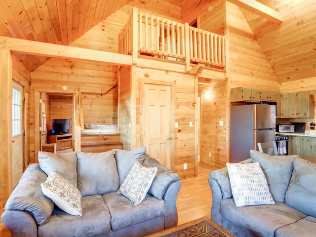 living area with high vaulted ceiling, light wood finished floors, wooden ceiling, and wooden walls