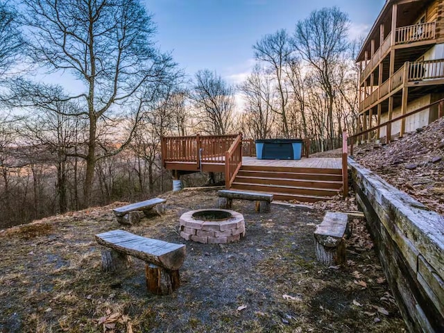 view of yard featuring an outdoor fire pit and a wooden deck