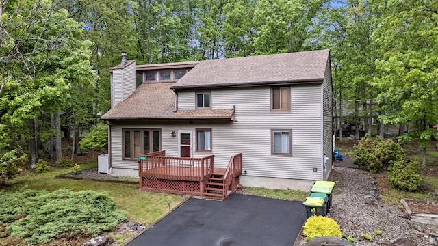 1117 Belaire Dr, East Stroudsburg, PA 18301 - rear view of house featuring a wooden deck, roof with shingles, a chimney, and a patio area
