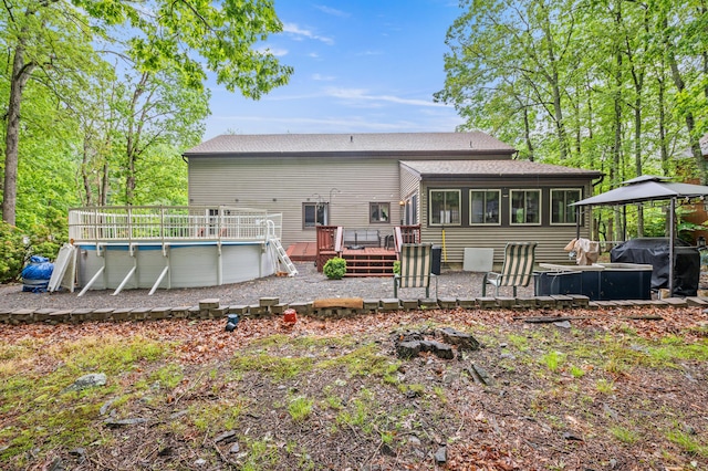 1117 Belaire Dr, East Stroudsburg, PA 18301 - back of property with a gazebo, a deck, an outdoor pool, and roof with shingles