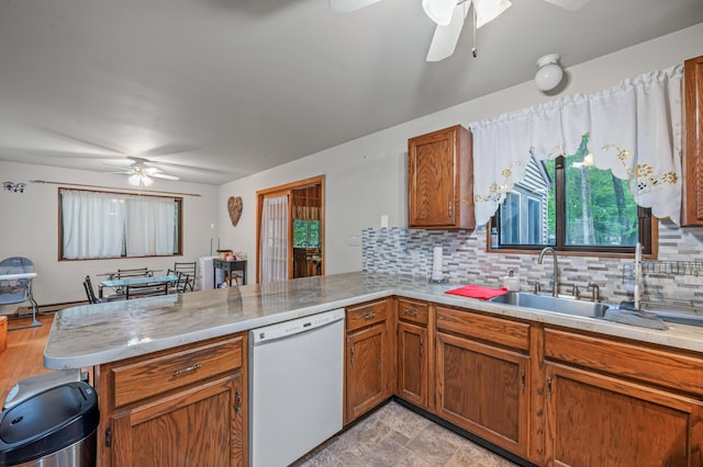 1117 Belaire Dr, East Stroudsburg, PA 18301 - kitchen featuring white dishwasher, ceiling fan, a peninsula, light countertops, and decorative backsplash