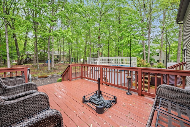 1117 Belaire Dr, East Stroudsburg, PA 18301 - deck with a pool and view of wooded area