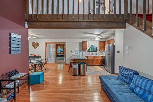 1117 Belaire Dr, East Stroudsburg, PA 18301 - living room featuring ceiling fan, light wood-style flooring, and a towering ceiling