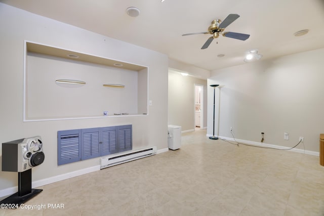 living area with a baseboard heating unit, a ceiling fan, and baseboards