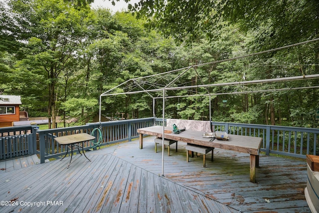 wooden deck with a forest view