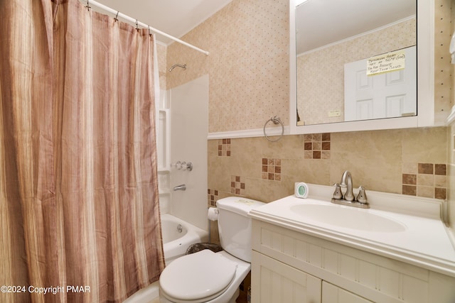 bathroom with toilet, vanity, tile walls, shower / bath combination with curtain, and wallpapered walls