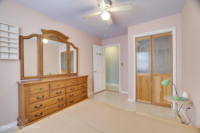 bedroom with a ceiling fan, a closet, and baseboards