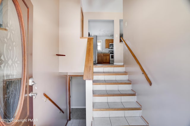 staircase featuring tile patterned flooring