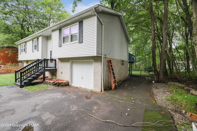 view of front of home with an attached garage and fence