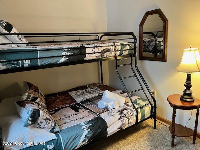 bedroom featuring carpet flooring and baseboards