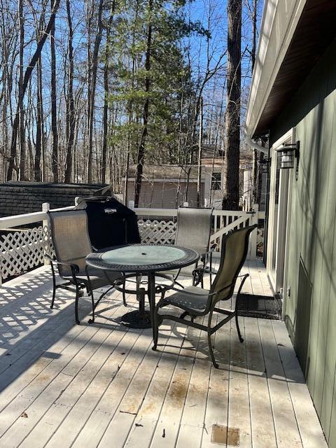 wooden terrace featuring outdoor dining area