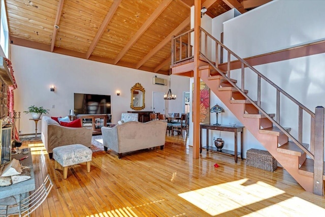 living room with beamed ceiling, hardwood / wood-style flooring, wood ceiling, and stairway