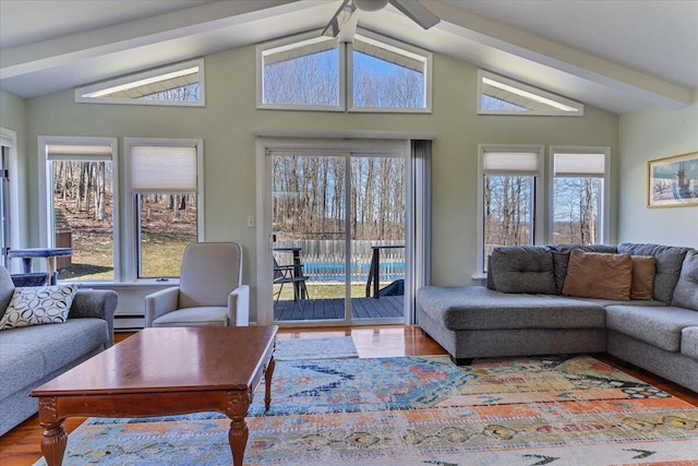 living area with a baseboard radiator, ceiling fan, vaulted ceiling, and wood finished floors