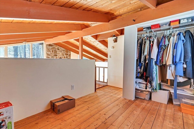 interior space with wooden ceiling, vaulted ceiling with beams, and light wood finished floors