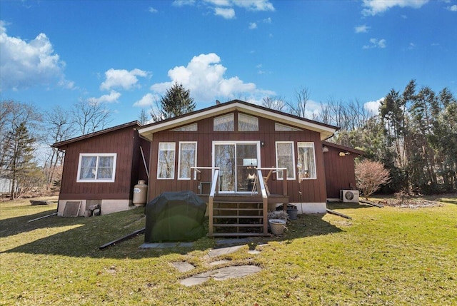 view of front of property with ac unit and a front lawn