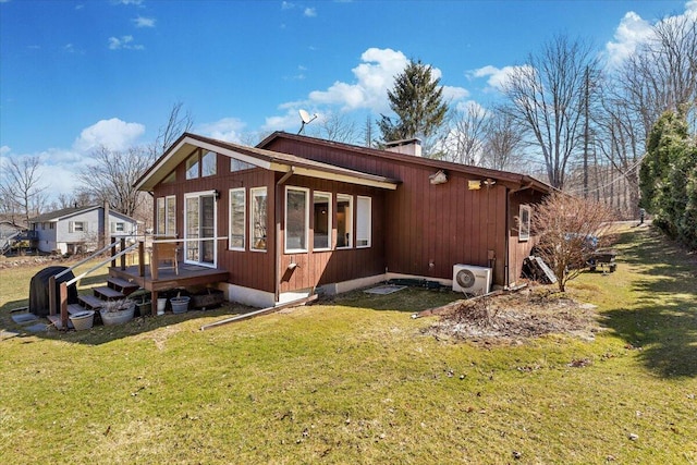 view of side of home featuring ac unit, a wooden deck, a yard, and a chimney