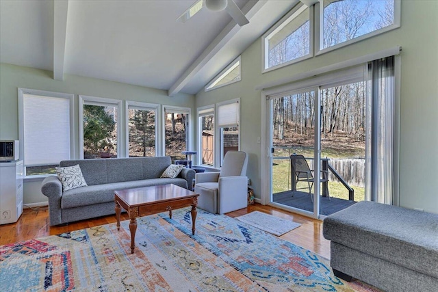 sunroom / solarium with high vaulted ceiling, wood finished floors, and beam ceiling