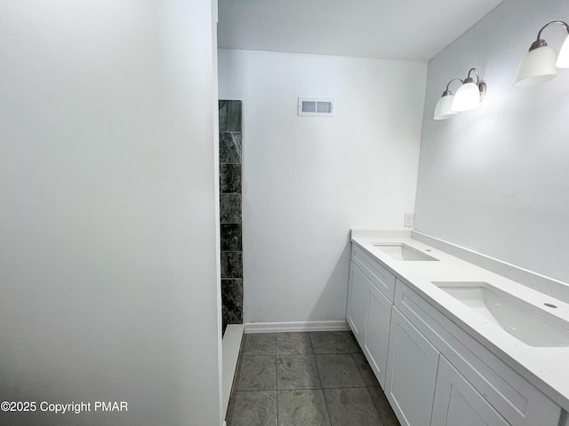 bathroom with baseboards, a sink, visible vents, and tile patterned floors