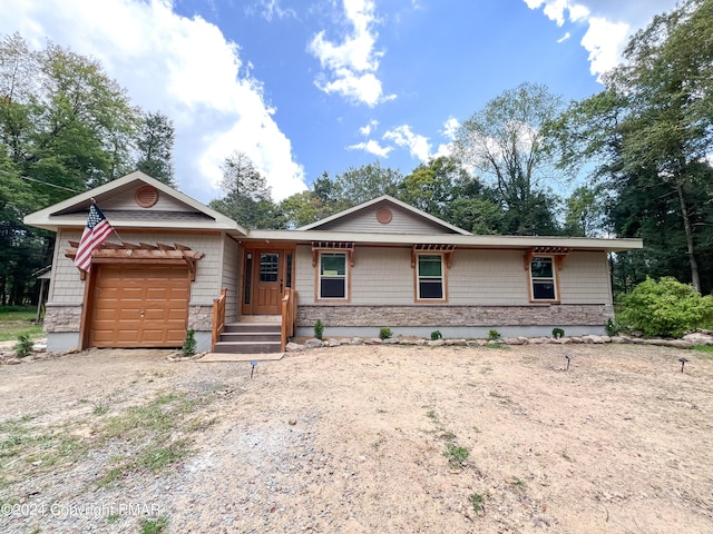 ranch-style house featuring a garage and driveway