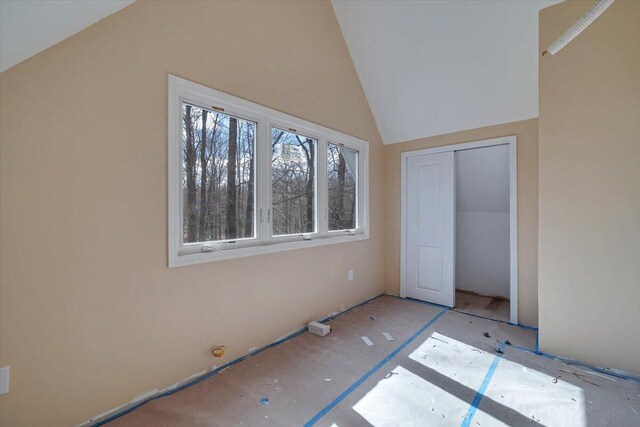 unfurnished bedroom with a closet and lofted ceiling