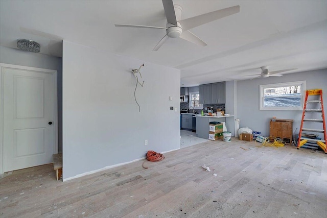 interior space with a sink, light wood-type flooring, plenty of natural light, and ceiling fan