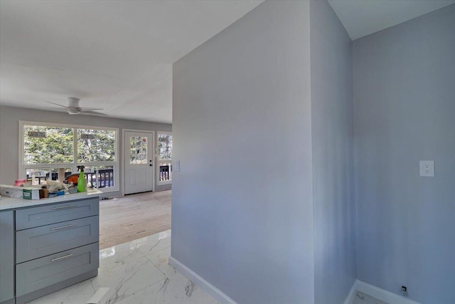 interior space with baseboards and marble finish floor