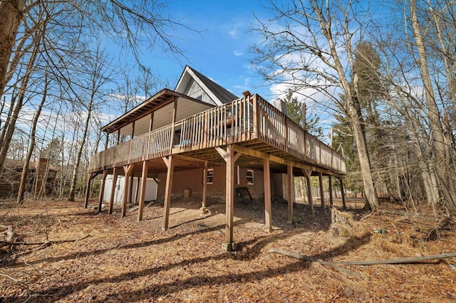 back of house with driveway and a wooden deck