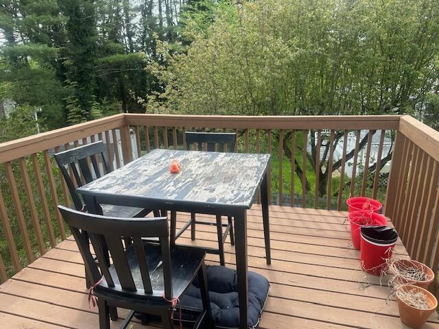 wooden terrace with outdoor dining space