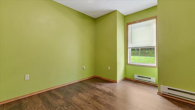 838 Cayuga Way, Stroudsburg, PA 18360 - empty room with baseboard heating and dark wood-style floors