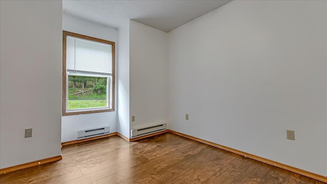 838 Cayuga Way, Stroudsburg, PA 18360 - empty room with a baseboard heating unit and wood finished floors