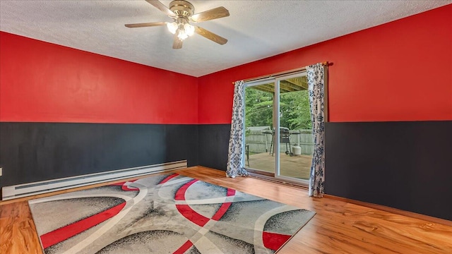 838 Cayuga Way, Stroudsburg, PA 18360 - interior space with baseboard heating, access to exterior, wood finished floors, a textured ceiling, and ceiling fan