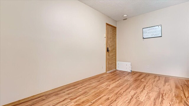 838 Cayuga Way, Stroudsburg, PA 18360 - unfurnished room with light wood-type flooring, a textured ceiling, and a smoke detector