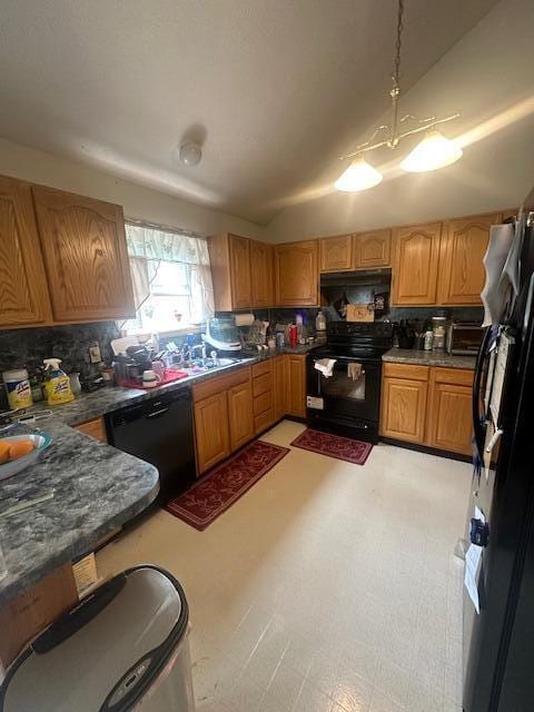 kitchen featuring a sink, dark countertops, backsplash, and black appliances