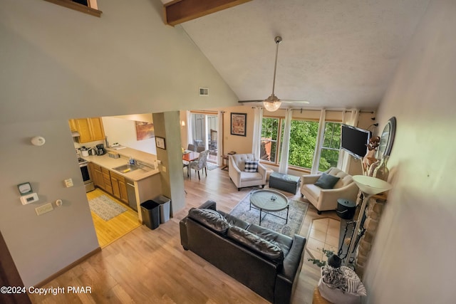 480 Spruce Dr, Tannersville, PA 18372 - living area with light wood-type flooring, high vaulted ceiling, ceiling fan, and beamed ceiling
