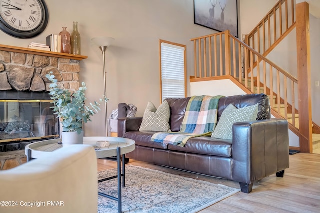480 Spruce Dr, Tannersville, PA 18372 - living area with wood finished floors, stairs, and a stone fireplace