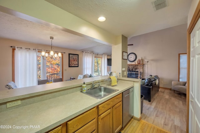 480 Spruce Dr, Tannersville, PA 18372 - kitchen featuring a sink, dishwasher, a fireplace, open floor plan, and a chandelier